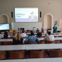 Participants watching a presentation. 